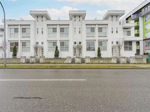 A modern white townhouse/apartment building