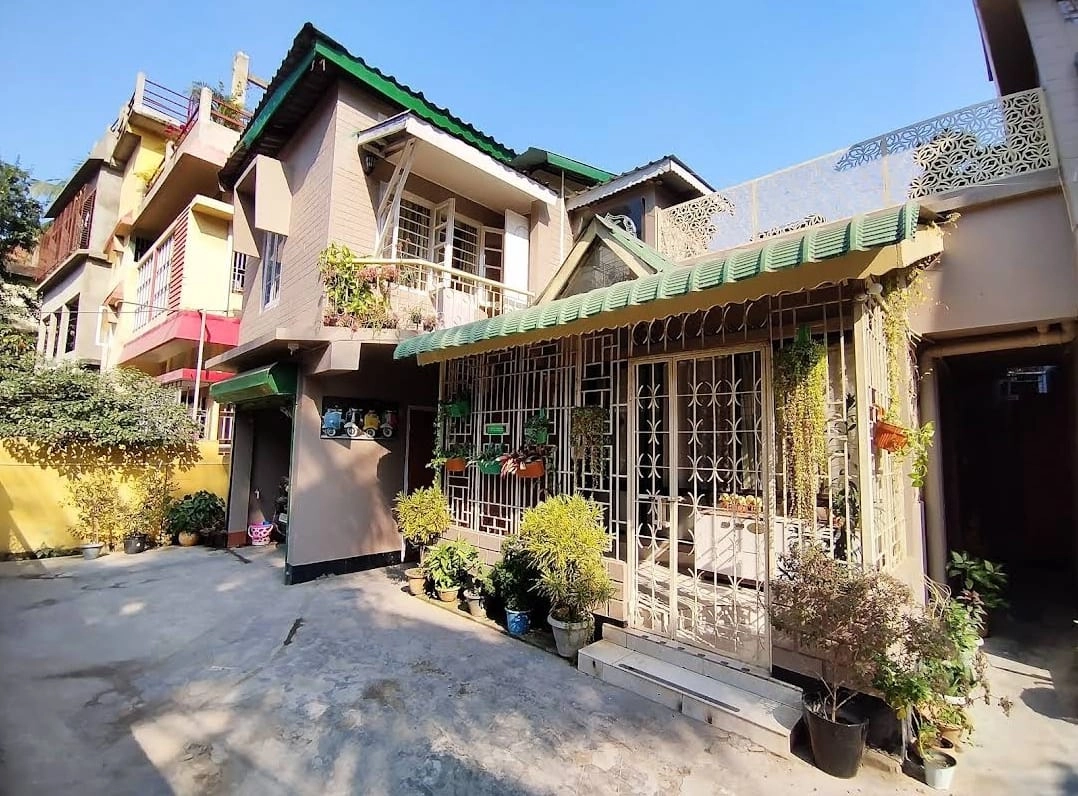 Homestay exterior with lush garden